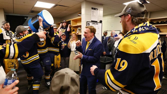 The Quinnipiac Bobcats give head coach Rand Pecknold a cooler bath after defeating the Minnesota Golden Gophers 3-2 in overtime to win the Division I Men’s Ice Hockey Championship Frozen Four.