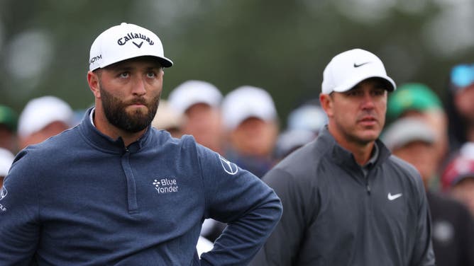 Jon Rahm and Brooks Koepka wait on the tee box at the Masters, probably for Patrick Cantlay to finish.