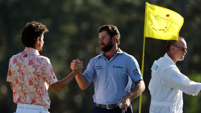 Joaquin Niemann of Chile shakes hands with Cameron Young of the United States on the 18th green during the final round of the 2023 Masters Tournament at Augusta National Golf Club.