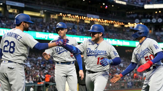 Dodgers' Max Muncy is congratulated by Mookie Betts and Freddie Freeman after Muncy hit a 3-run HR vs. the Giants in the at Oracle Park in San Francisco.
