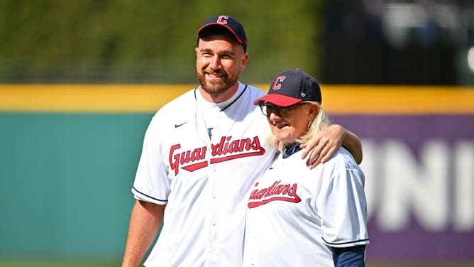 Cleveland area native and Kansas City Chiefs player Travis Kelce stands with his mom Donna before throwing out the first pitch prior to the home opener between the Cleveland Guardians and the Seattle Mariners. The Royals are giving Kelce a second chance next week after he threw a poor pitch in Cleveland.