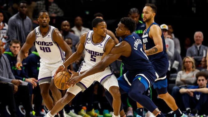 Timberwolves wing Anthony Edwards tries to strip Sacramento Kings PG De'Aaron Fox at Target Center in Minneapolis.
