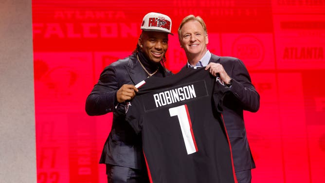 RB Bijan Robinson poses with NFL Commissioner Roger Goodell after being selected 8th by the Atlanta Falcons during the 1st round of the 2023 NFL Draft at Union Station in Kansas City, Missouri.