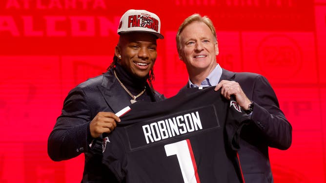Running back Bijan Robinson poses with NFL Commissioner Roger Goodell after being selected eighth overall by the Atlanta Falcons during the first round of the 2023 NFL Draft.