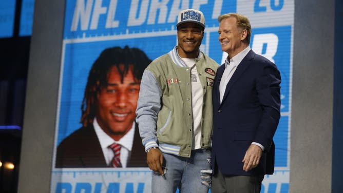 NFL Commissioner Roger Goodell speaks with Brian Branch, selected by the Detroit Lions in the second round of the 2023 NFL Draft.