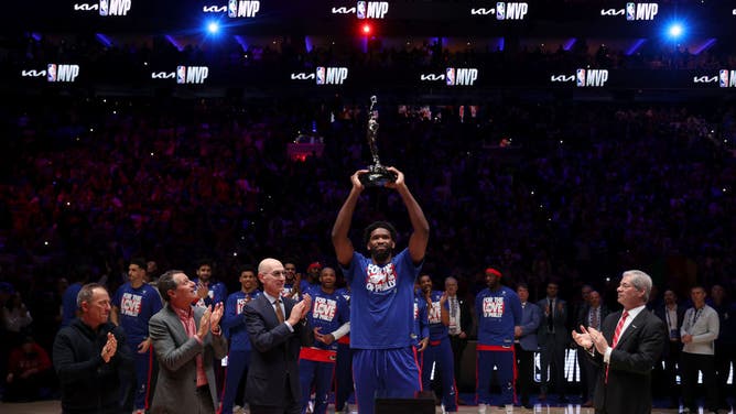 76ers C Joel Embiid hoists the trophy after being named 2022-23 Kia NBA MVP prior to Game 3 of the Eastern Conference Semifinals against the Boston Celtics at Wells Fargo Center in Philadelphia.