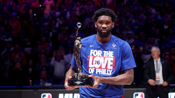 Joel Embiid of the Philadelphia 76ers poses with the MVP trophy.