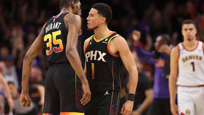 Suns Devin Booker celebrates with Kevin Durant after a 3-pointer shot vs. the Nuggets during Game 3 of the NBA Western Conference Semifinals at Footprint Center in Phoenix, Arizona.