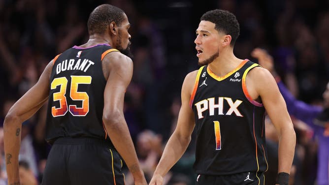 Suns' Devin Booker and Kevin Durant celebrate during Game 3 of the NBA Western Conference Semifinals at Footprint Center in Phoenix, Arizona.