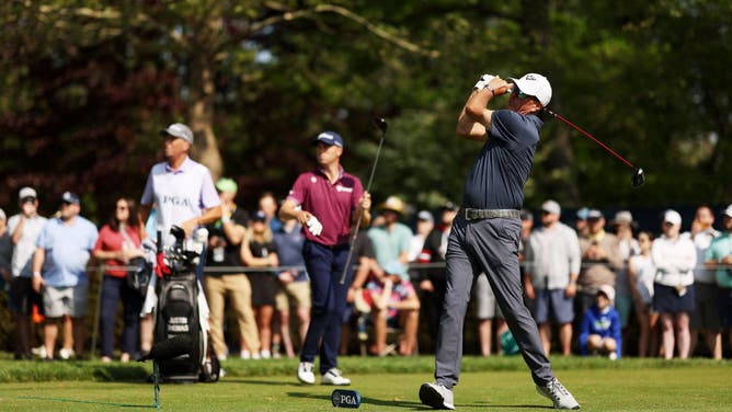 Phil Mickelson of the United States plays his shot from the eighth tee as Justin Thomas of the United States and caddie Jim 'Bones' Mackay look on during the final round of the 2023 PGA Championship at Oak Hill Country Club on May 21, 2023 in Rochester, New York.