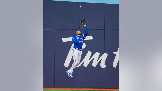 Kevin Kiermaier #39 of the Toronto Blue Jays makes a jumping catch against the Baltimore Orioles during the sixth inning in their MLB game at the Rogers Centre on May 20, 2023 in Toronto, Ontario, Canada.