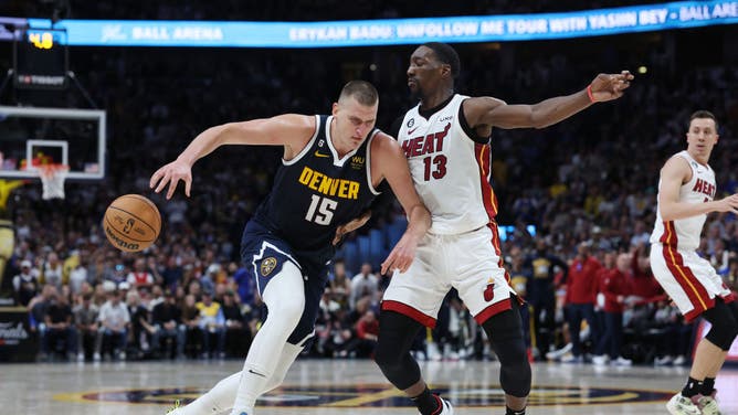 Denver Nuggets C Nikola Jokic drives the ball on Miami Heat C Bam Adebayo in Game 2 of the 2023 NBA Finals at Ball Arena in Colorado.