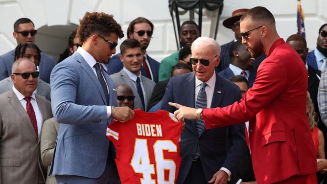 Quarterback Patrick Mahomes and tight end Travis Kelce of the Kansas City Chiefs present U.S. President Joe Biden with a team jersey at the White House.