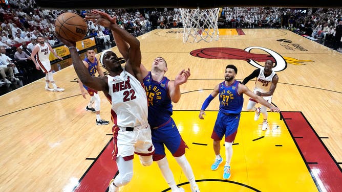 Heat SF Jimmy Butler drives to the cup on Denver Nuggets C Nikola Jokic in Game 3 of the 2023 NBA Finals at Kaseya Center.