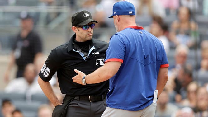 Home plate umpire Alex MacKay ejects Chicago Cubs manager David Ross from Sunday's game against the New York Yankees in the first inning.