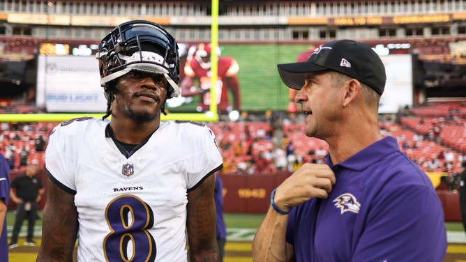 Baltimore Ravens QB Lamar Jackson chats with head coach John Harbaugh at FedExField  in Landover, Maryland.