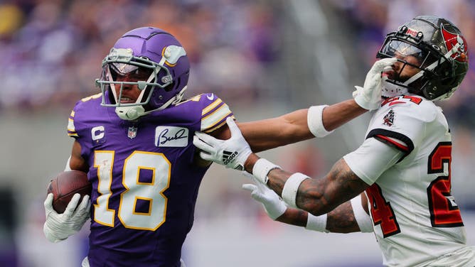 Justin Jefferson catches a pass from Minnesota Vikings QB Kirk Cousins and then stiff arms Carlton Davis III of the Tampa Bay Buccaneers.