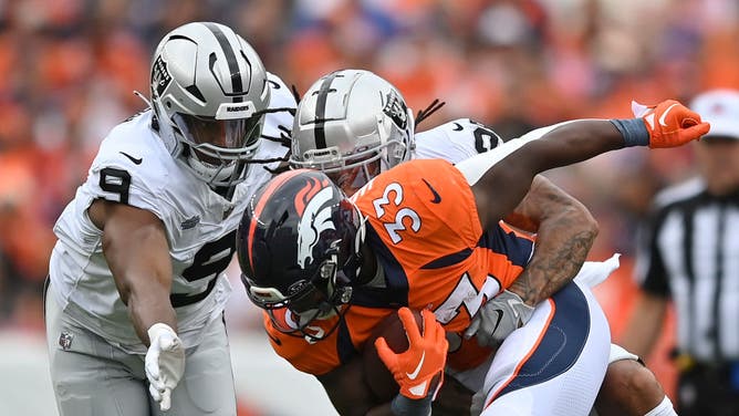 Broncos RB Javonte Williams is tackled by the Las Vegas Raiders at Empower Field At Mile High in Denver, Colorado.