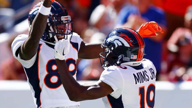 Brandon Johnson of the Denver Broncos celebrates with Marvin Mims Jr. of the Denver Broncos after Mims' receiving touchdown during the first quarter against the Washington Commanders at Empower Field At Mile High on September 17, 2023 in Denver, Colorado.