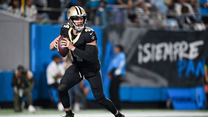 New Orleans Saints QB Derek Carr rolls out to pass vs. the Panthers at Bank of America Stadium in Charlotte, North Carolina.
