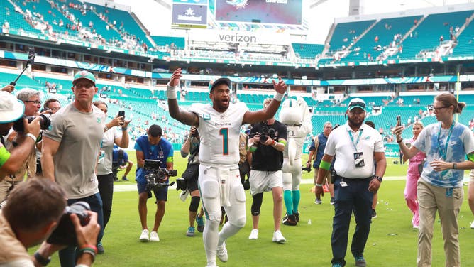 Dolphins QB Tua Tagovailoa pumps up the crowd after Miami's 70-20 win over the Denver Broncos at Hard Rock Stadium in Miami.