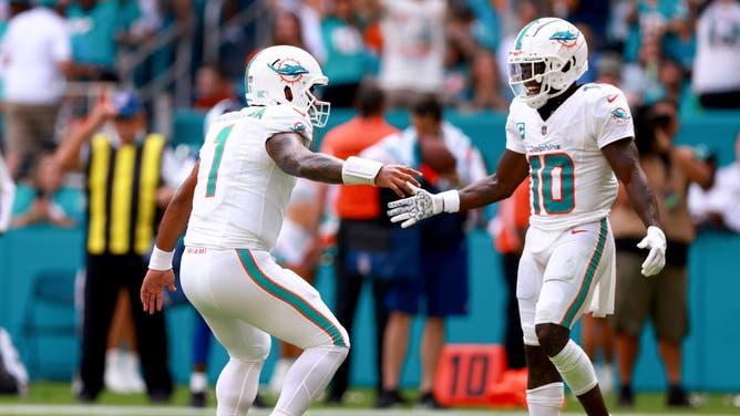 Dolphins QB Tua Tagovailoa and WR Tyreek Hill celebrate after a TD vs. the Denver Broncos at Hard Rock Stadium.
