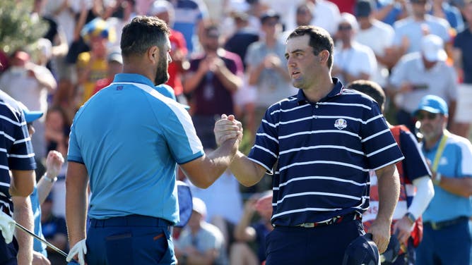 Jon Rahm and Scottie Scheffler shake hands after their Friday morning Foursomes match in the 2023 Ryder Cup at Marco Simone Golf Club.
