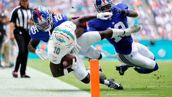 Tyreek Hill of the Miami Dolphins runs the ball against the New York Giants during the first quarter at Hard Rock Stadium on October 08, 2023 in Miami Gardens, Florida.