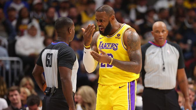 LeBron James of the Los Angeles Lakers talks to a referee during an NBA game.