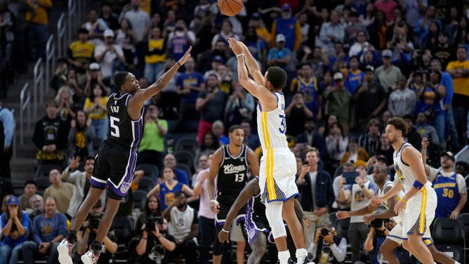 Golden State Warriors' Stephen Curry makes a 3-pointer shot over Sacramento Kings PG De'Aaron Fox at Chase Center in San Francisco.