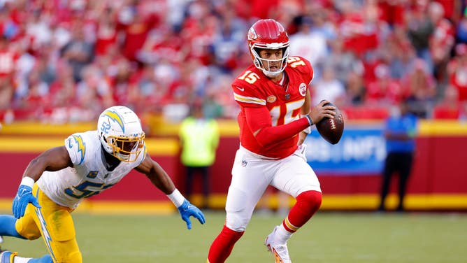 Chiefs QB Patrick Mahomes evades pressure from the Los Angeles Chargers at GEHA Field at Arrowhead Stadium in Kansas City, Missouri.
