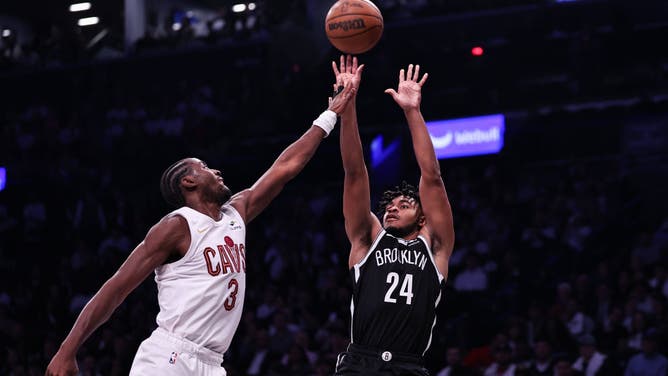 Nets SG Cam Thomas shoots the ball over the Cleveland Cavaliers wing Caris LeVert at Barclays Center in Brooklyn.