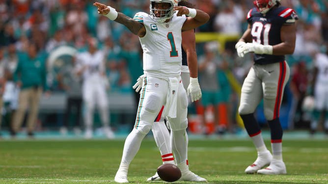 Dolphins QB Tua Tagovailoa signals for a 1st down vs. the New England Patriots at Hard Rock Stadium in Miami.