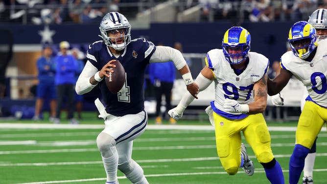 Dallas Cowboys QB Dak Prescott evades pressure from the Los Angeles Rams at AT&T Stadium in Arlington, Texas.