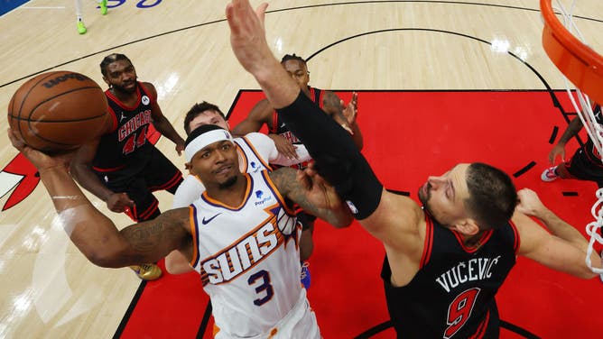 Phoenix Suns SG Bradley Beal attacks the rim against Bulls big Nikola Vucevic at the United Center in Chicago.