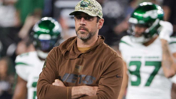 Quarterback Aaron Rodgers of the New York Jets stands on the field during warmups before a game against the Las Vegas Raiders.