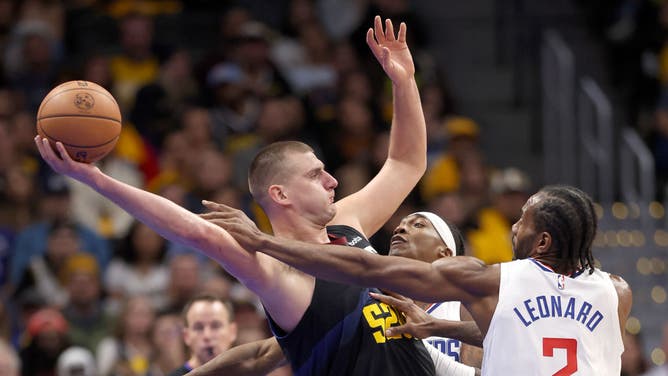 Nuggets C Nikola Jokic tries to keep the ball away from Los Clippers wings Terance Mann and Kawhi Leonard at Ball Arena in Denver, Colorado.