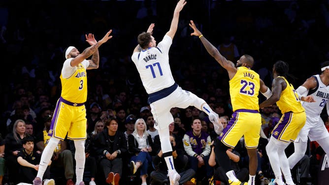Dallas Mavericks All-Star Luka Doncic shoots a fadeaway over Lakers big Anthony Davis and LeBron James at Crypto.com Arena in Los Angeles.