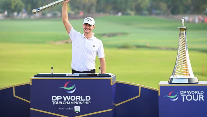 Nicolai Højgaard lifts the DP World Tour Championship trophy on the Earth Course at Jumeirah Golf Estates in Dubai, United Arab Emirates.