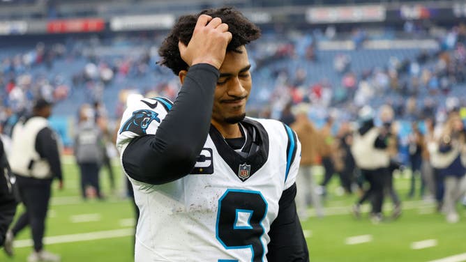 Bryce Young #9 of the Carolina Panthers walks off the field after a loss against the Tennessee Titans.