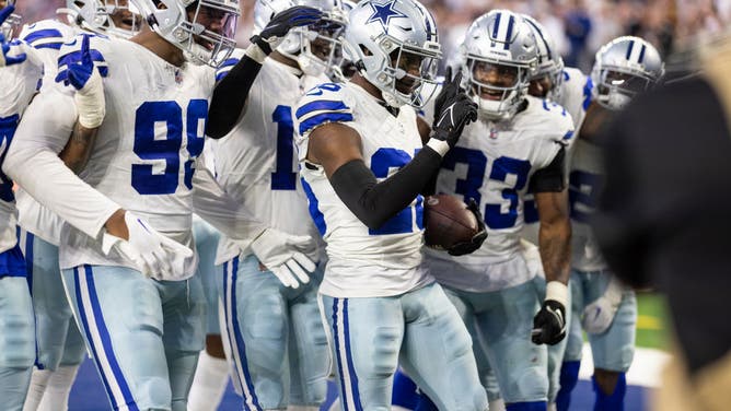 Cowboys cornerback DaRon Bland celebrates with teammates after an interception against the Seahawks