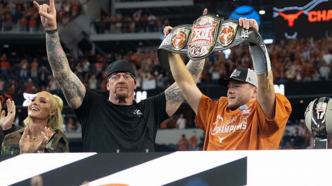 Texas Longhorns QB Quinn Ewers celebrates a Big XII conference championship with WWE's The Undertaker at AT&T Stadium in Arlington, Texas.