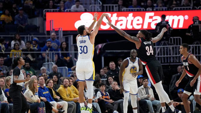 Golden State Warriors' All-Star Steph Curry shoots a 3-point shot over Portland Trail Blazers wing Jabari Walker at Chase Center in San Francisco.