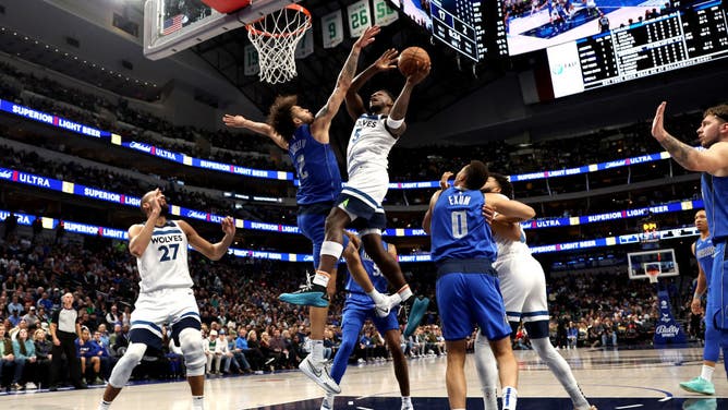 Minnesota Timberwolves All-Star Anthony Edwards drives to the basket on Mavericks big Dereck Lively in an NBA game at American Airlines Center in Dallas.