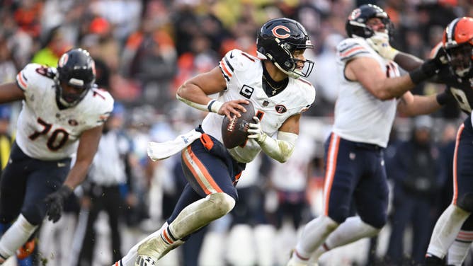 Justin Fields of the Chicago Bears runs with the ball  during the fourth quarter of a game against the Cleveland Browns at Cleveland Browns Stadium.