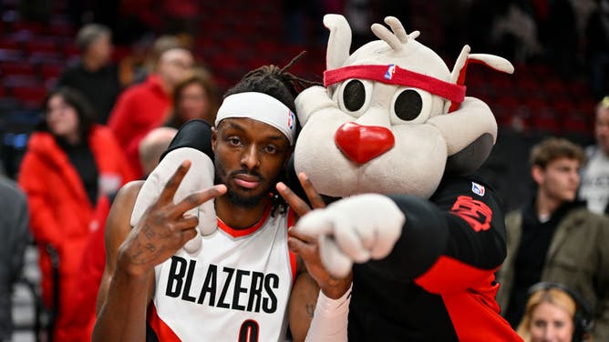 Trail Blazers wing Jerami Grant and Blaze the Trail Cat take a pic after an NBA game vs. the Phoenix Suns at the Moda Center in Portland, Oregon.