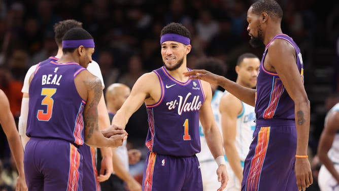 Suns All-Stars Devin Booker, Bradley Beal, and Kevin Durant after scoring vs. the Charlotte Hornets at Footprint Center in Phoenix, Arizona.