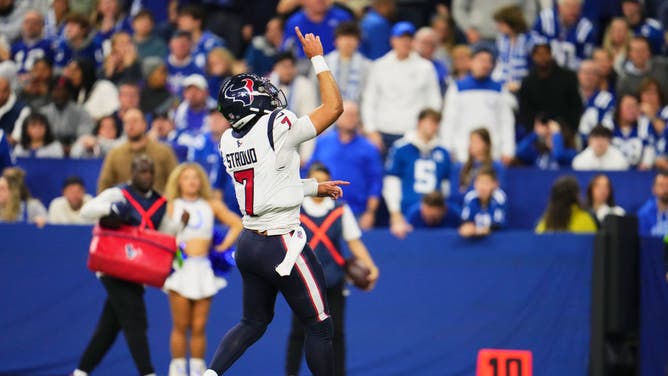 Houston Texans QB C.J. Stroud points to the heavens after scoring a TD vs. the Colts at Lucas Oil Stadium in Indianapolis.