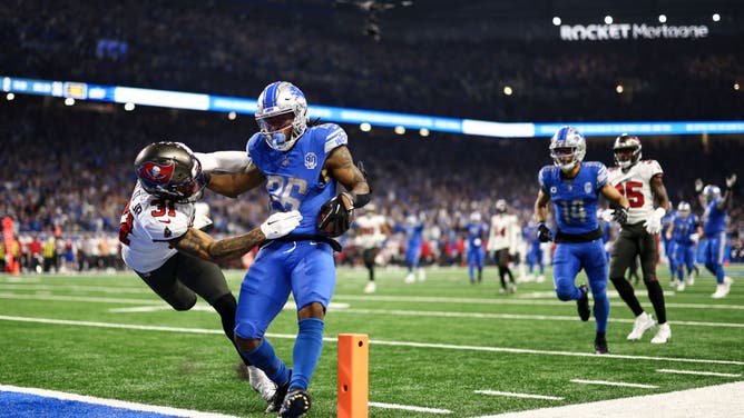 Lions RB Jahmyr Gibbs stiff arms Tampa Bay Buccaneers safety Antoine Winfield Jr. while scoring a TD in the NFL divisional round at Ford Field in Detroit, Michigan.