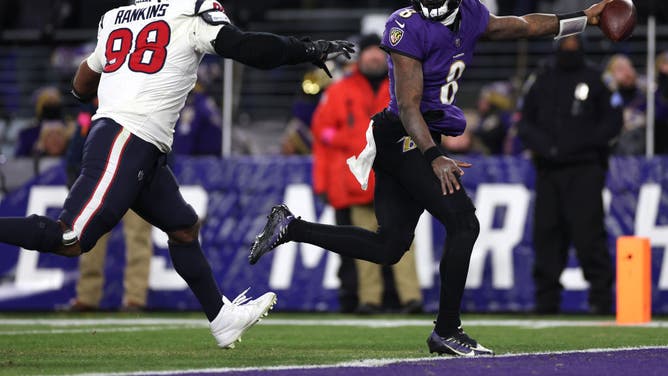 Ravens QB Lamar Jackson rushes for an 8-yard TD against the Houston Texans during the fourth quarter in the AFC divisional round at M&T Bank Stadium in Baltimore, Maryland.